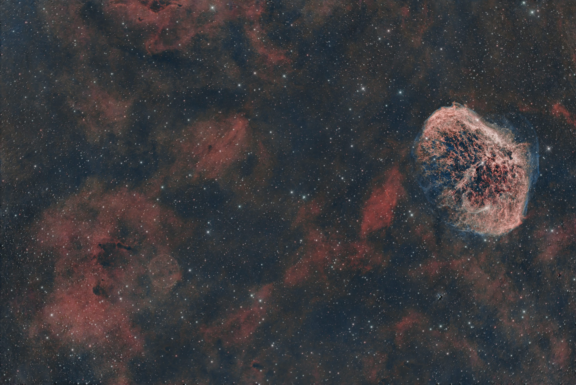 The Crescent Moon Nebula NGC 6888 is a peculiar emission nebula in the constellation Cygnus, excited to glow by the Wolf-Rayet star at the nebula's center.